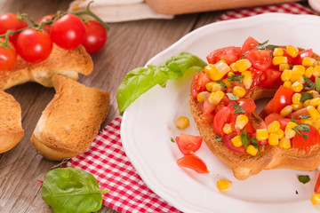 Friselle with tomatoes and mais.	