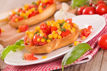 Friselle with tomatoes and mais.	