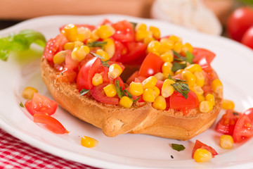 Friselle with tomatoes and mais.	