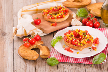 Friselle with tomatoes and mais.	