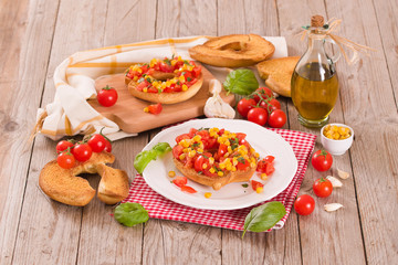 Friselle with tomatoes and mais.	