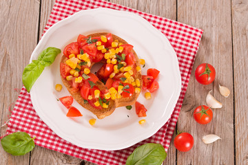 Friselle with tomatoes and mais.	