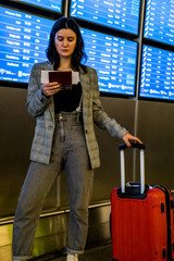 Fototapeta na wymiar Young woman at international airport moving to terminal gate for airplane travel trip - Mobility concept and aerospace industry flight connections