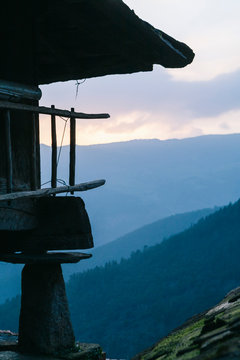 Detail of a horreo typical construction of rural village with views of the mountain valley with forest at sunrise
