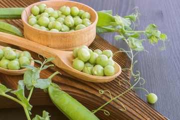 young fresh green peas on a wooden Board. new crop