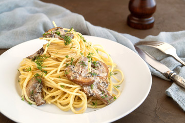 Spaghetti with mushrooms in cream sauce. on dark background