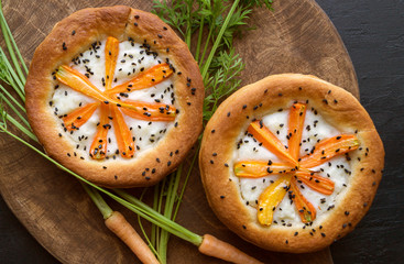 Rustic pie with carrots. On a dark background.
