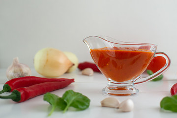 Red hot chili sauce in a gravy boat