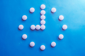 9 o clock made of pills. Abstract medical background. Medication time concept. Medicine drug icon. Time to take medicine.