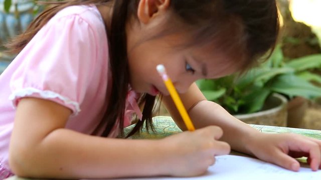 Thai child writing book  at home, Chiangmai Thailand