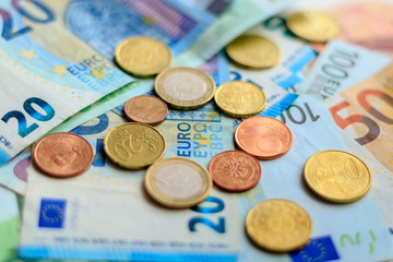 Background from euro banknotes and euro cents. World of money