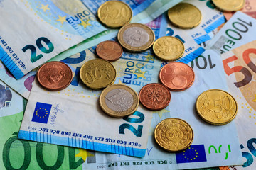Background from euro banknotes and euro cents. World of money