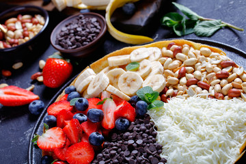 Bright moon pancake with berries, peanuts, cheese