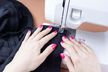 Hands on the sewing machine