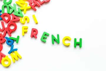 Learn French. Concept with letters on white background top-down copy space