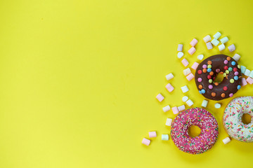 donut and marshmallow on a yellow background. top view photo