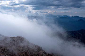 Fototapeta na wymiar Beautiful view to Western Taurus mountain range with cloudy sky, captured from Tahtali mountain's peak.
