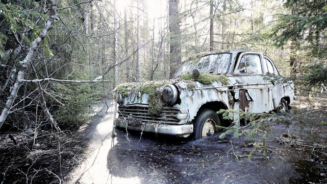 Old Abandoned Car Stuck In Frozen Flood In The Forest In Southern Finland. 