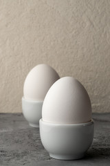 Two white chicken eggs in egg cup