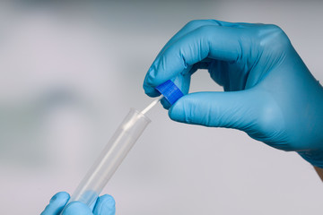 Close up of handling a smear test in a medical laboratory