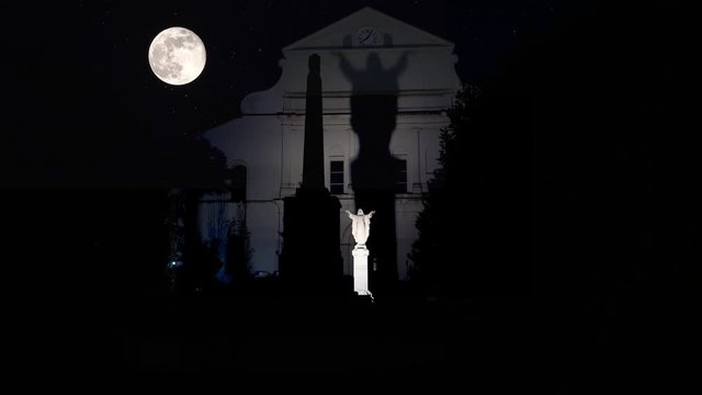 Jesus Christ statue with the huge shadow by Full Moon. New Orleans, Louisiana, USA