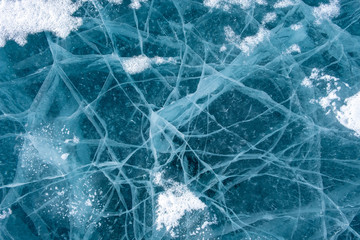 Cracks in the ice. Frozen lake surface.