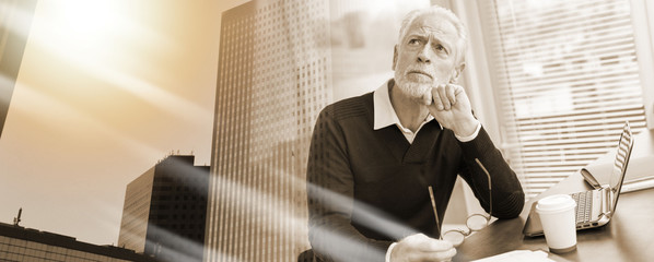 Portrait of thoughtful senior businessman; multiple exposure