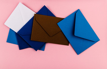 Colorful envelopes on a pink background.