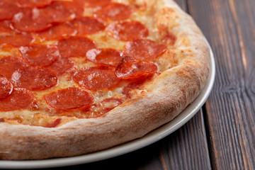 tasty pizza on the wooden background