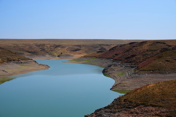 Blue lake in steppe canyon with blue sky. Natural landscape. Beautiful landscape. Beauty nature background. Beautiful sky. Kurty or Kurtinskoye lake.