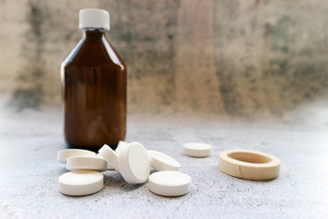 pills and bottle of medicine on white background