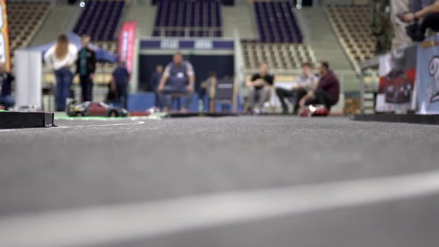 RC drift cars on track. RC electric drift cars on the road bend to the left. RC cars on an asphalt polygon drifting. Racing battery charged cars controlled with a remote controller. 