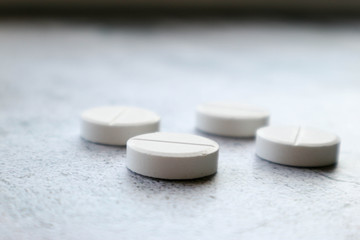 Large round pills on the stone table close up