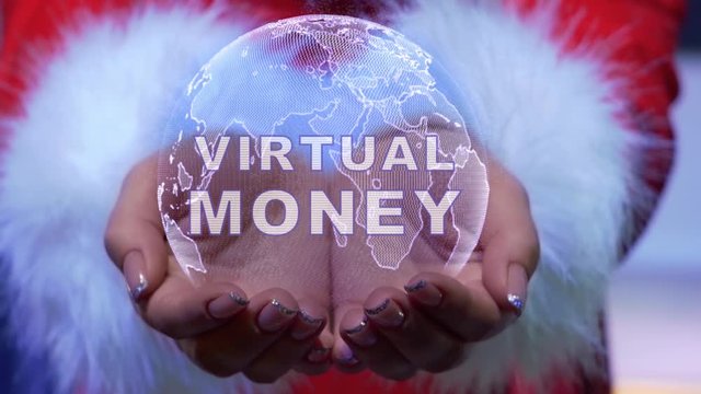 Female hands holding a conceptual hologram of planet Earth with text Virtual money. Woman in red clothes with faux white fur with future holographic technology