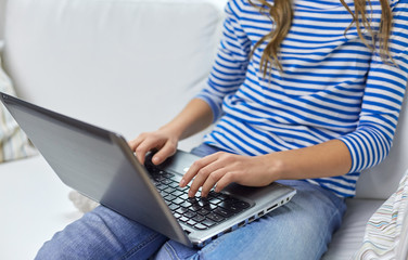 education, technology and people concept - close up of teenage student girl with laptop and books at home