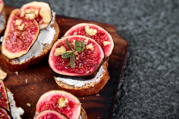 Bruschetta  or ctostini with cottage cheese, figs and honey. Sandwich with figs and goat cheese..