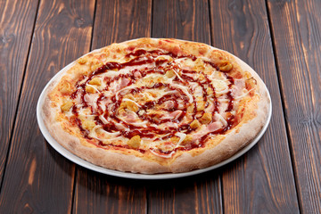 tasty pizza on the wooden background