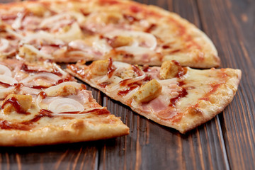 tasty pizza on the wooden background