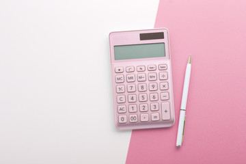 Pink gold calculator with pen, background with space, top view