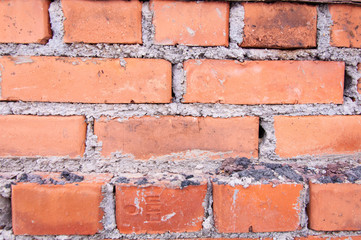Fototapeta premium red brick house wall masonry under snow, background, texture, red brick masonry