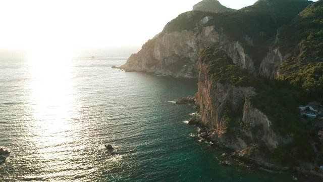 Beautiful cliffs on mediterranean coast in Greece during sunset aerial footage