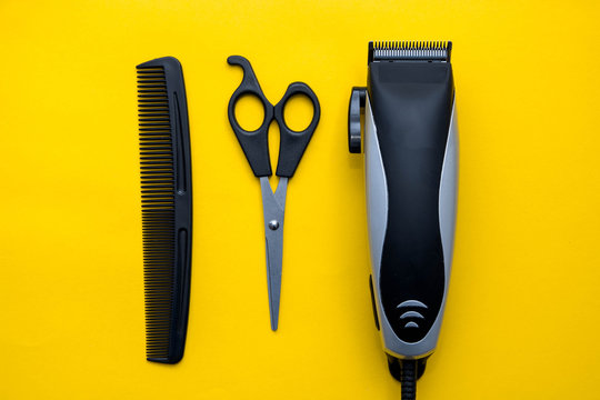Set for a hairdresser on a yellow background. Top view. Copy, empty space for text