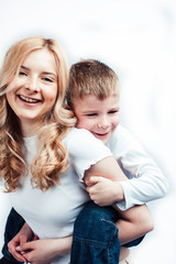 young modern blond curly mother with cute son together happy smiling family posing cheerful on white background, lifestyle people concept, sister and brother friends