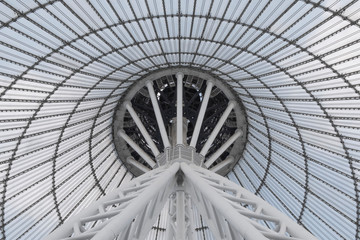 Giant metall colums holding a top of giant conic roof construction. Frame of unusual roof construction.