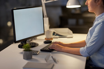 business, deadline and technology concept - businesswoman with computer working at night office