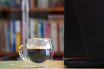 Transparent double wall glass mug with espresso coffee  at home at work