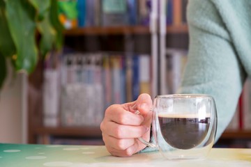 Transparent double wall glass mug with espresso coffee  at home at work