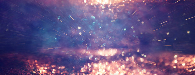 background of abstract glitter lights. gold and black. de focused