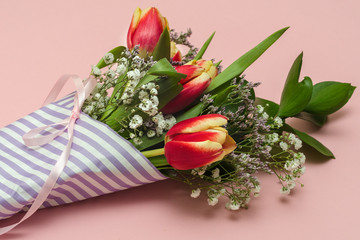 bouquet of tulips for International Women's Day on March 8 on a pink background