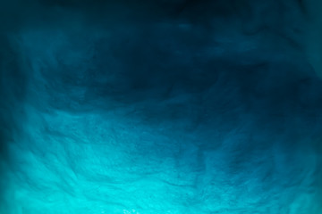 Abstract image of blue illuminated cotton candy in plastic jar, background texture.